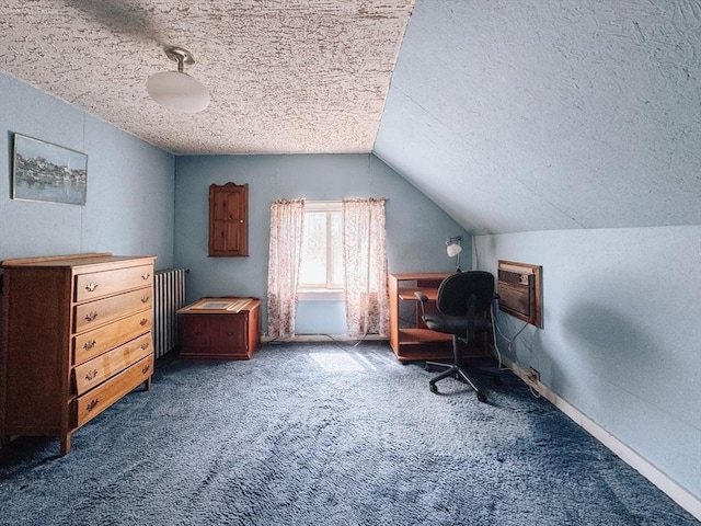 office space featuring a textured ceiling, carpet, lofted ceiling, a wall mounted AC, and baseboards