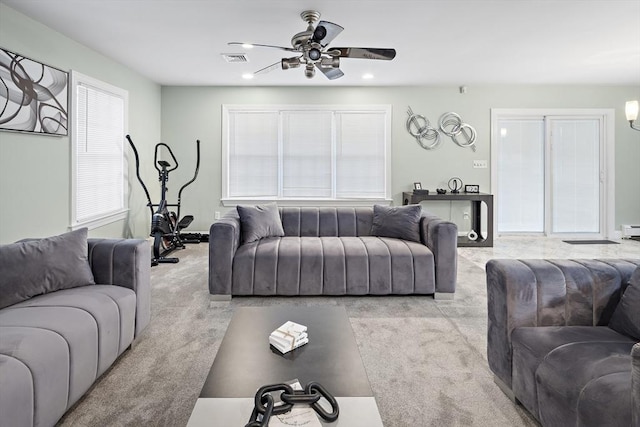 carpeted living room featuring ceiling fan and a healthy amount of sunlight