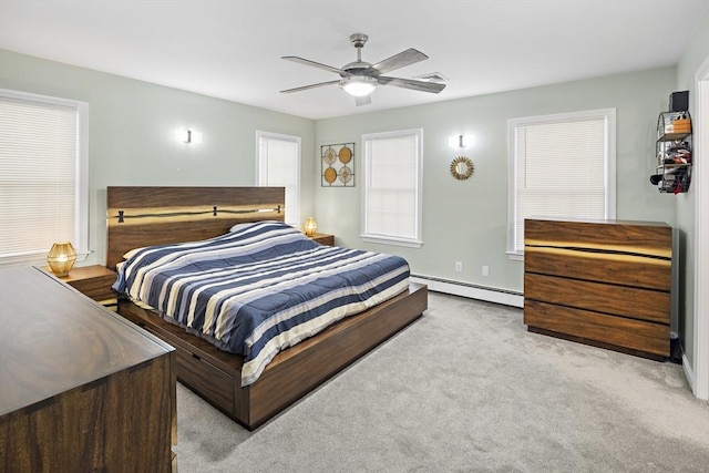 carpeted bedroom featuring baseboard heating and ceiling fan