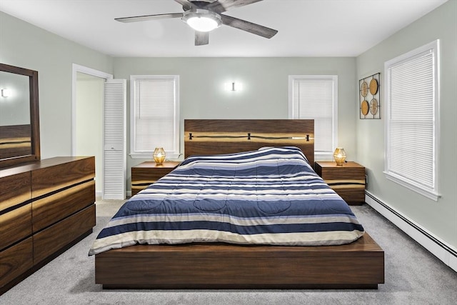 bedroom featuring baseboard heating, ceiling fan, and carpet floors