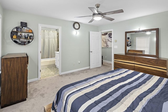 carpeted bedroom with ceiling fan and ensuite bath