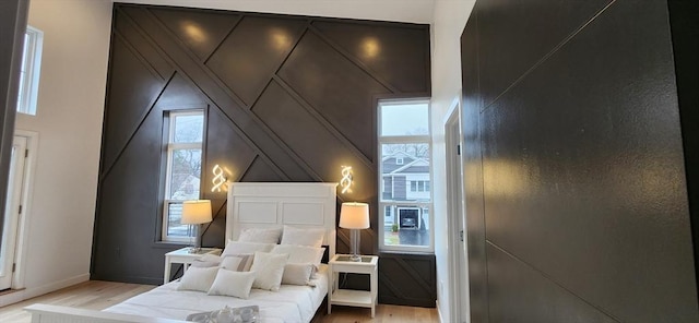 bedroom featuring light wood-style flooring and baseboards