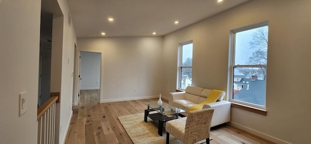 sitting room featuring recessed lighting, light wood-style flooring, and baseboards