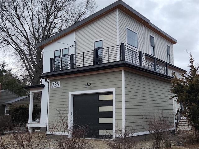 exterior space with a garage and a balcony