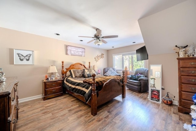 bedroom featuring light wood-style floors, ceiling fan, and baseboards