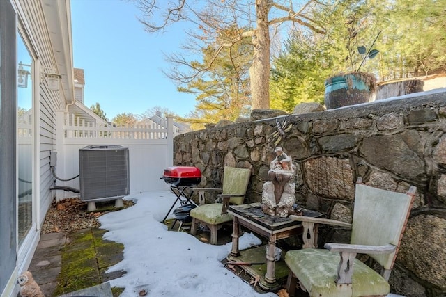 view of patio / terrace featuring central AC unit and fence