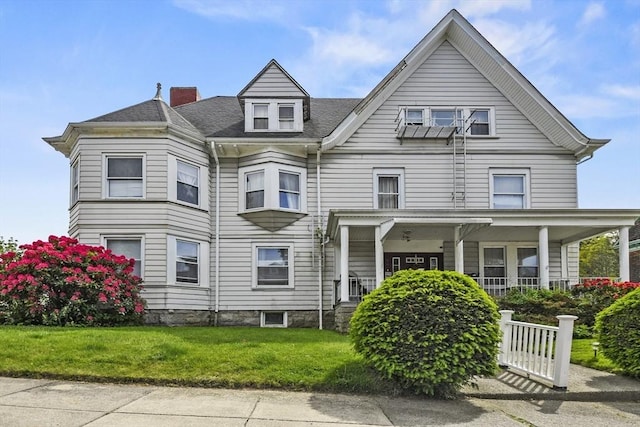 257 French St, Fall River, MA 02720 - view of front of property with a chimney, a front lawn, and covered porch