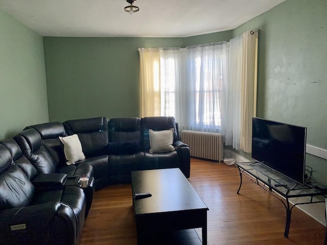 257 French St, Fall River, MA 02720 - living area with radiator heating unit and wood finished floors