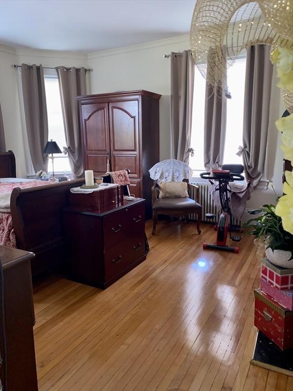 257 French St, Fall River, MA 02720 - living room with light wood-style floors and crown molding