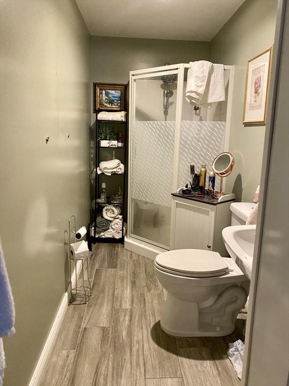 257 French St, Fall River, MA 02720 - full bathroom featuring wood finished floors, toilet, and a shower stall