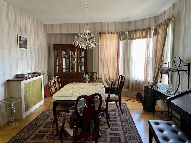 257 French St, Fall River, MA 02720 - dining area with wallpapered walls, a chandelier, and light wood-style floors
