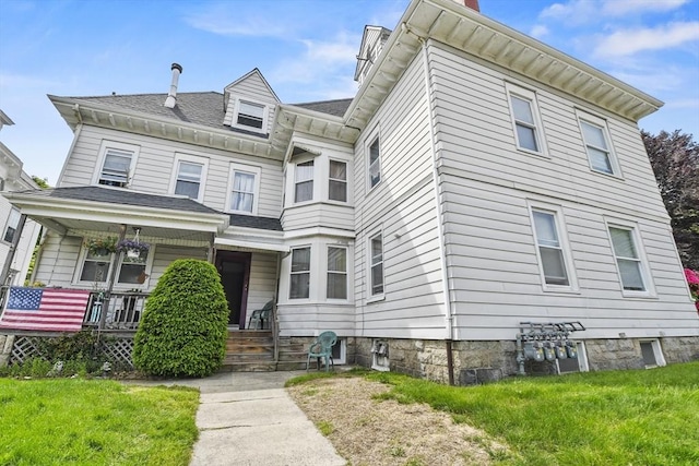 257 French St, Fall River, MA 02720 - view of front of house featuring a porch, a front yard, and a chimney