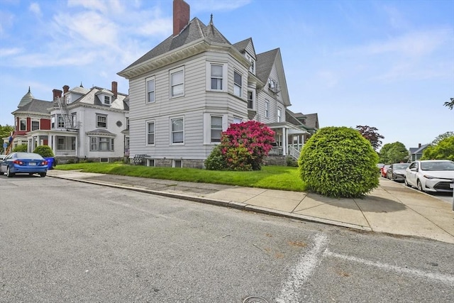 257 French St, Fall River, MA 02720 - view of property exterior with a chimney