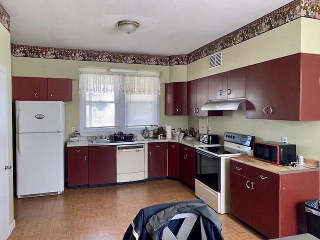 257 French St, Fall River, MA 02720 - kitchen featuring white appliances, under cabinet range hood, and light countertops