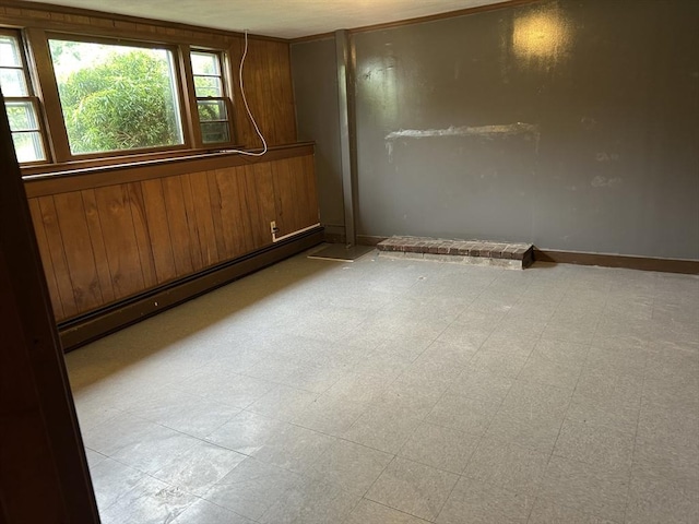 14 Rogers Cir, Braintree, MA 02184 - spare room with a baseboard heating unit, wood walls, and baseboards