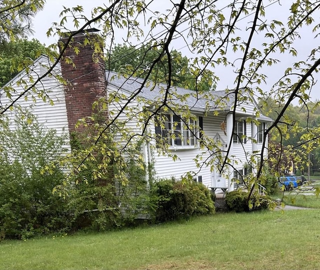 14 Rogers Cir, Braintree, MA 02184 - view of side of home with a yard, a chimney, and a shingled roof