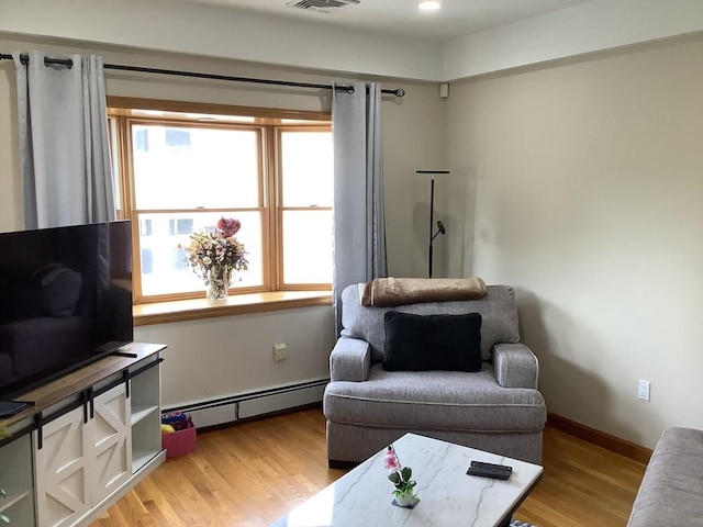 11 Dyer, Everett, MA 02149 - living room featuring baseboard heating, light wood-style floors, baseboards, and recessed lighting
