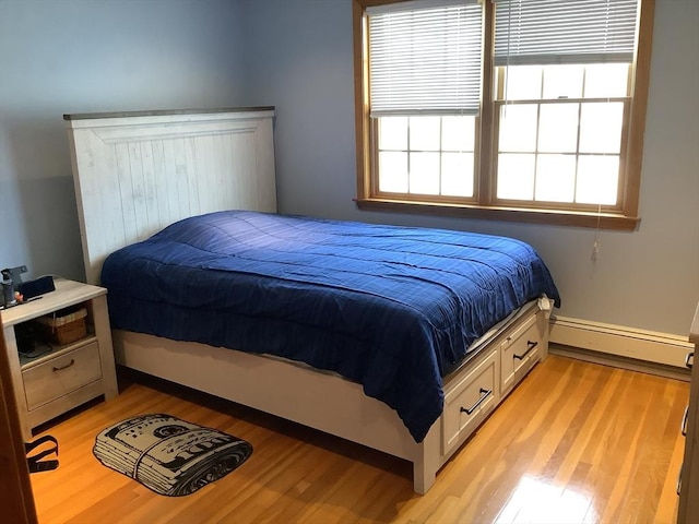 11 Dyer, Everett, MA 02149 - bedroom with a baseboard radiator, light wood-style flooring, and baseboards