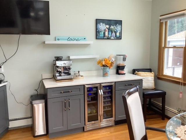 11 Dyer, Everett, MA 02149 - indoor dry bar featuring beverage cooler, a baseboard radiator, light wood finished floors, and baseboards