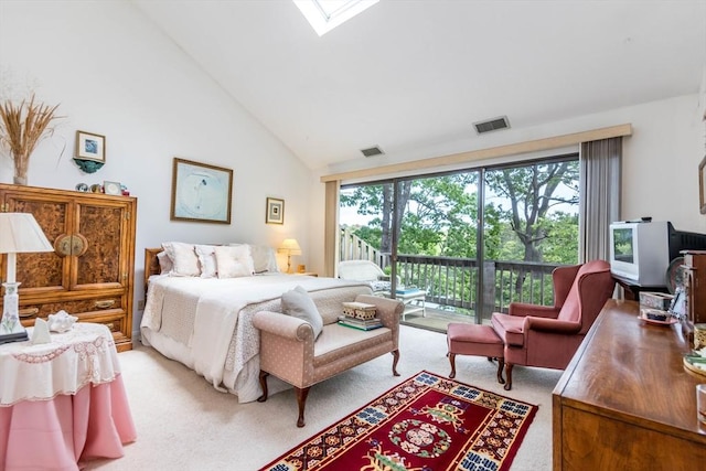bedroom featuring light carpet, access to outside, high vaulted ceiling, and a skylight