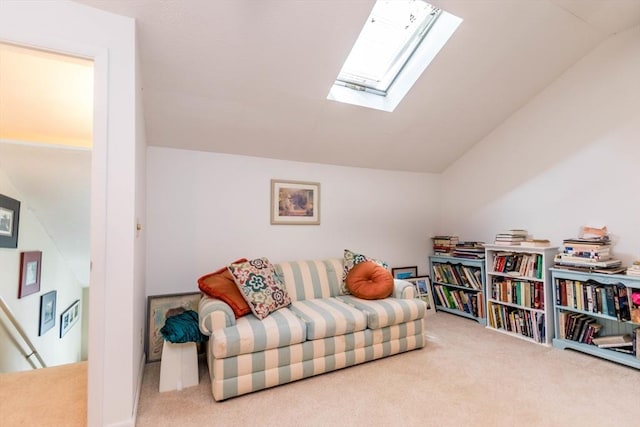 sitting room with carpet flooring, lofted ceiling, and a skylight