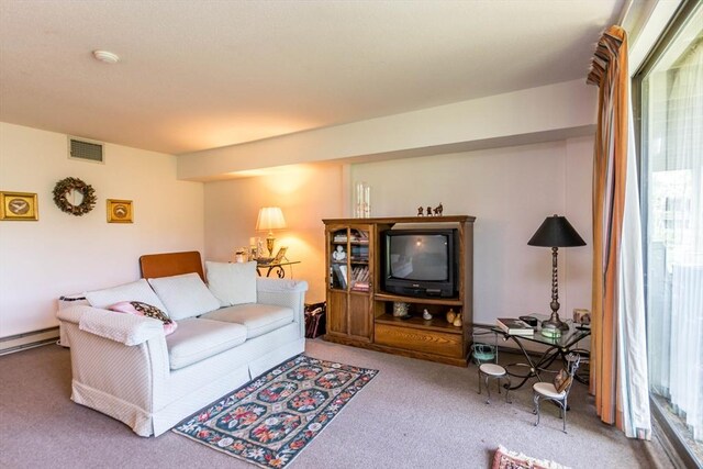 living room featuring carpet, plenty of natural light, and baseboard heating