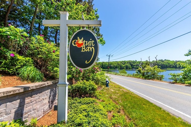community sign with a water view