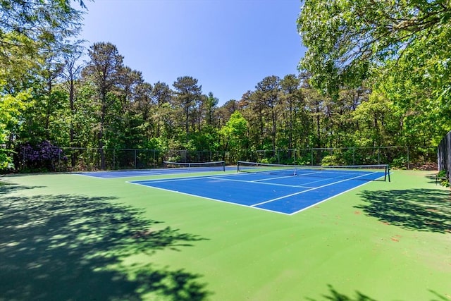 view of tennis court with fence