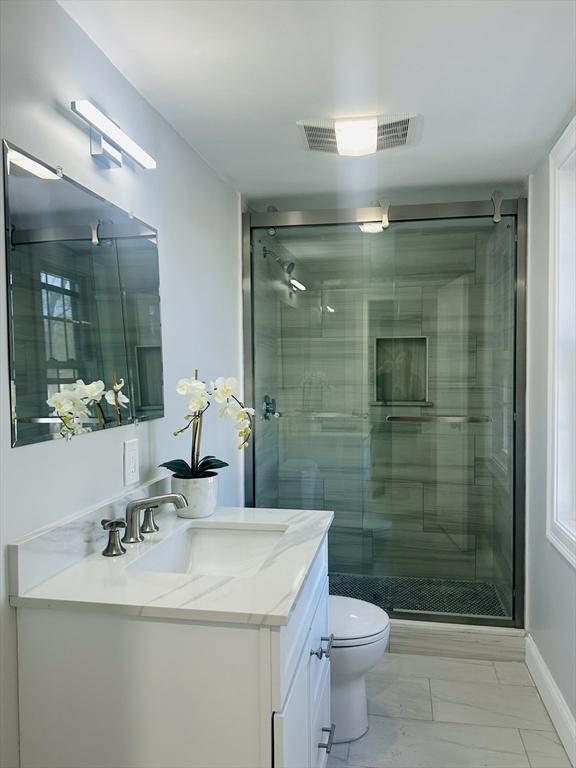 full bath featuring toilet, visible vents, a shower stall, and vanity