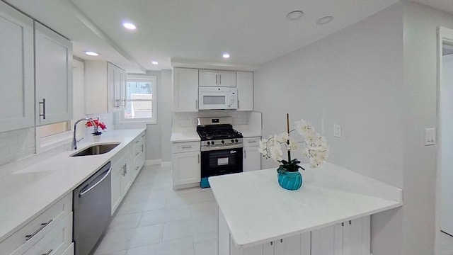 kitchen with recessed lighting, a sink, appliances with stainless steel finishes, and backsplash