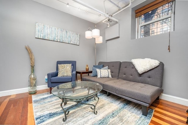 living area with wood finished floors and baseboards