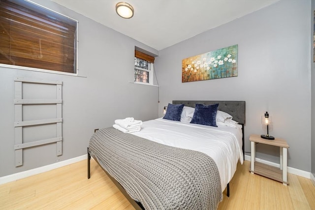 bedroom with wood finished floors and baseboards