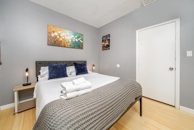 bedroom with light wood-style floors and baseboards