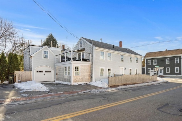 166 Water St Unit 166, Newburyport, MA 01950 - view of side of home featuring a balcony, fence, a chimney, a garage, and driveway