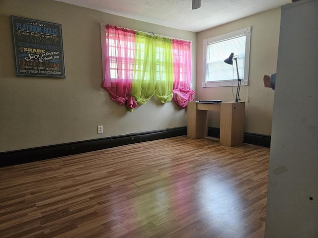 unfurnished room with wood finished floors
