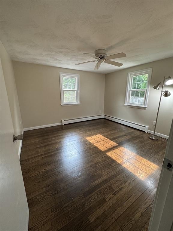 464 Church St, Raynham, MA 02767 - unfurnished room featuring healthy amount of natural light, a ceiling fan, baseboards, and dark wood-style flooring