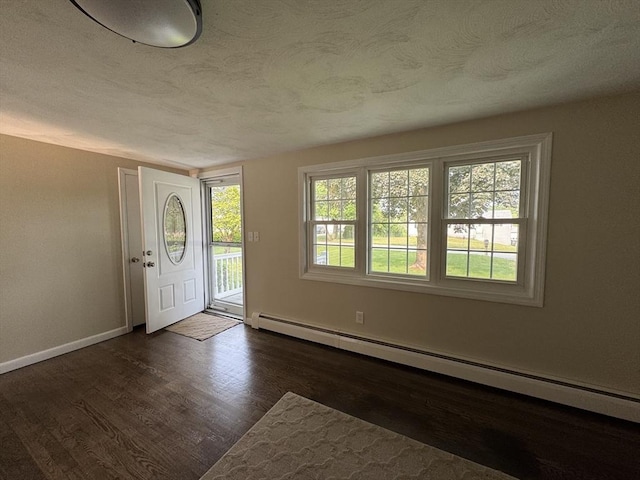 464 Church St, Raynham, MA 02767 - entrance foyer featuring a baseboard radiator, dark wood-style floors, a textured ceiling, and baseboards
