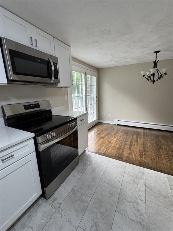 464 Church St, Raynham, MA 02767 - kitchen featuring stainless steel appliances, a baseboard heating unit, white cabinets, light countertops, and a textured ceiling