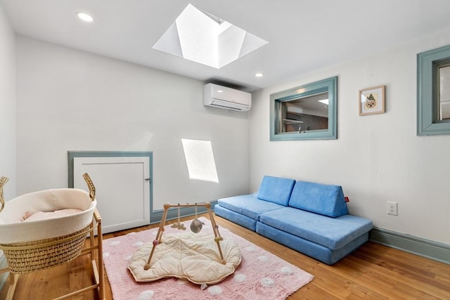113 Bray St, Gloucester, MA 01930 - living room featuring a wall unit AC, a skylight, wood finished floors, and recessed lighting