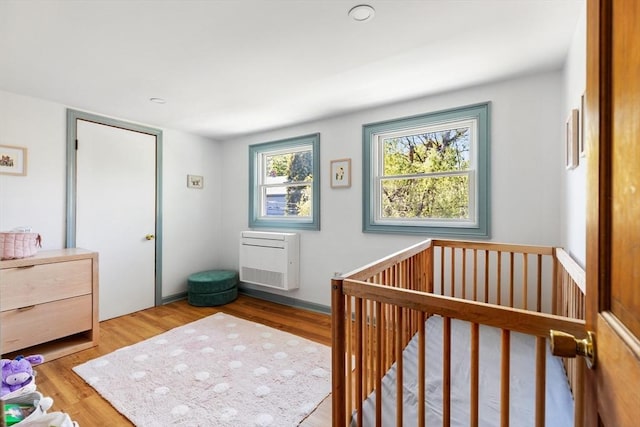 113 Bray St, Gloucester, MA 01930 - bedroom featuring wood finished floors and a crib