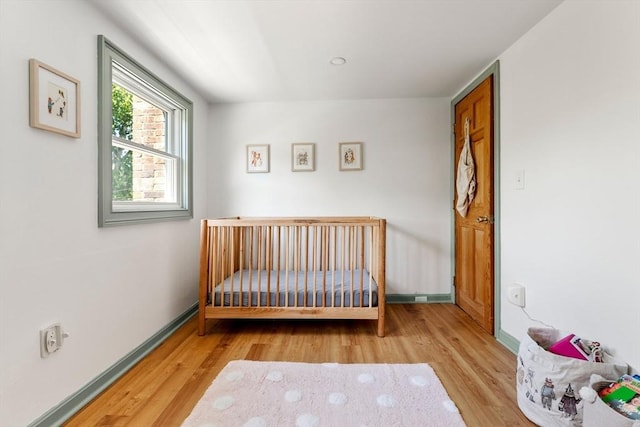 113 Bray St, Gloucester, MA 01930 - bedroom featuring wood finished floors and a crib