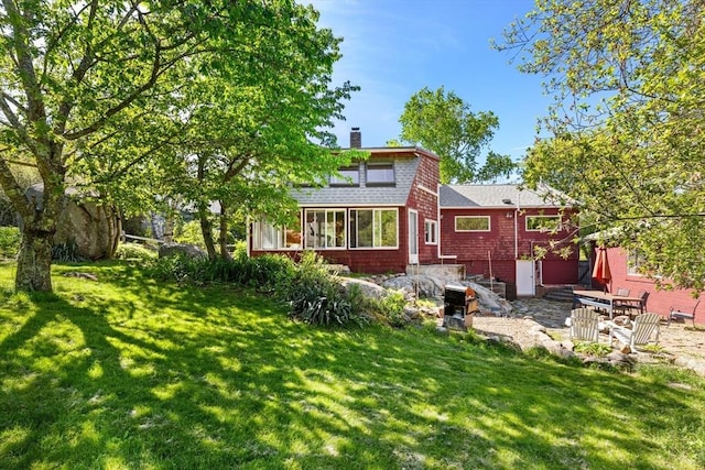 113 Bray St, Gloucester, MA 01930 - back of house with a yard, a chimney, and roof with shingles