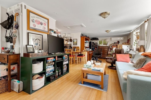 113 Bray St, Gloucester, MA 01930 - living room with attic access, wood finished floors, and a wall mounted air conditioner