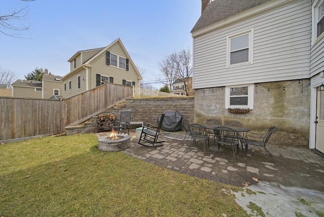 view of yard featuring a patio area, a fire pit, and fence