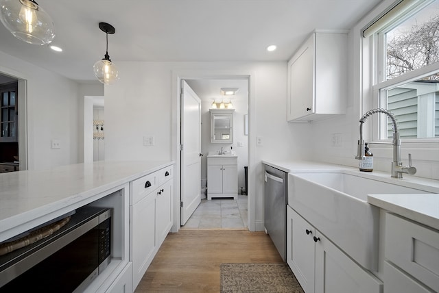 kitchen with pendant lighting, appliances with stainless steel finishes, white cabinets, and recessed lighting