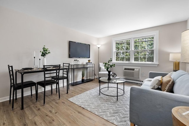 234 Low St Unit 16, Newburyport, MA 01950 - living area featuring a wall mounted air conditioner, wood finished floors, and a baseboard heating unit