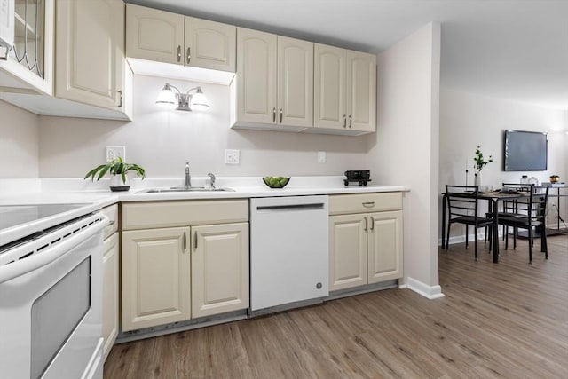 234 Low St Unit 16, Newburyport, MA 01950 - kitchen with white appliances, light wood-style flooring, light countertops, and cream cabinetry
