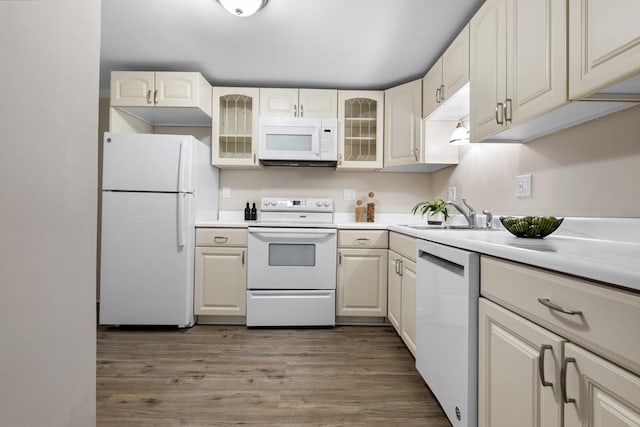 234 Low St Unit 16, Newburyport, MA 01950 - kitchen featuring white appliances, wood finished floors, glass insert cabinets, and light countertops