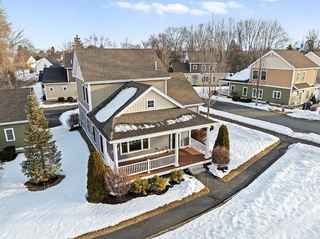 exterior space featuring a shingled roof, a residential view, and a porch