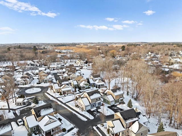 snowy aerial view with a residential view